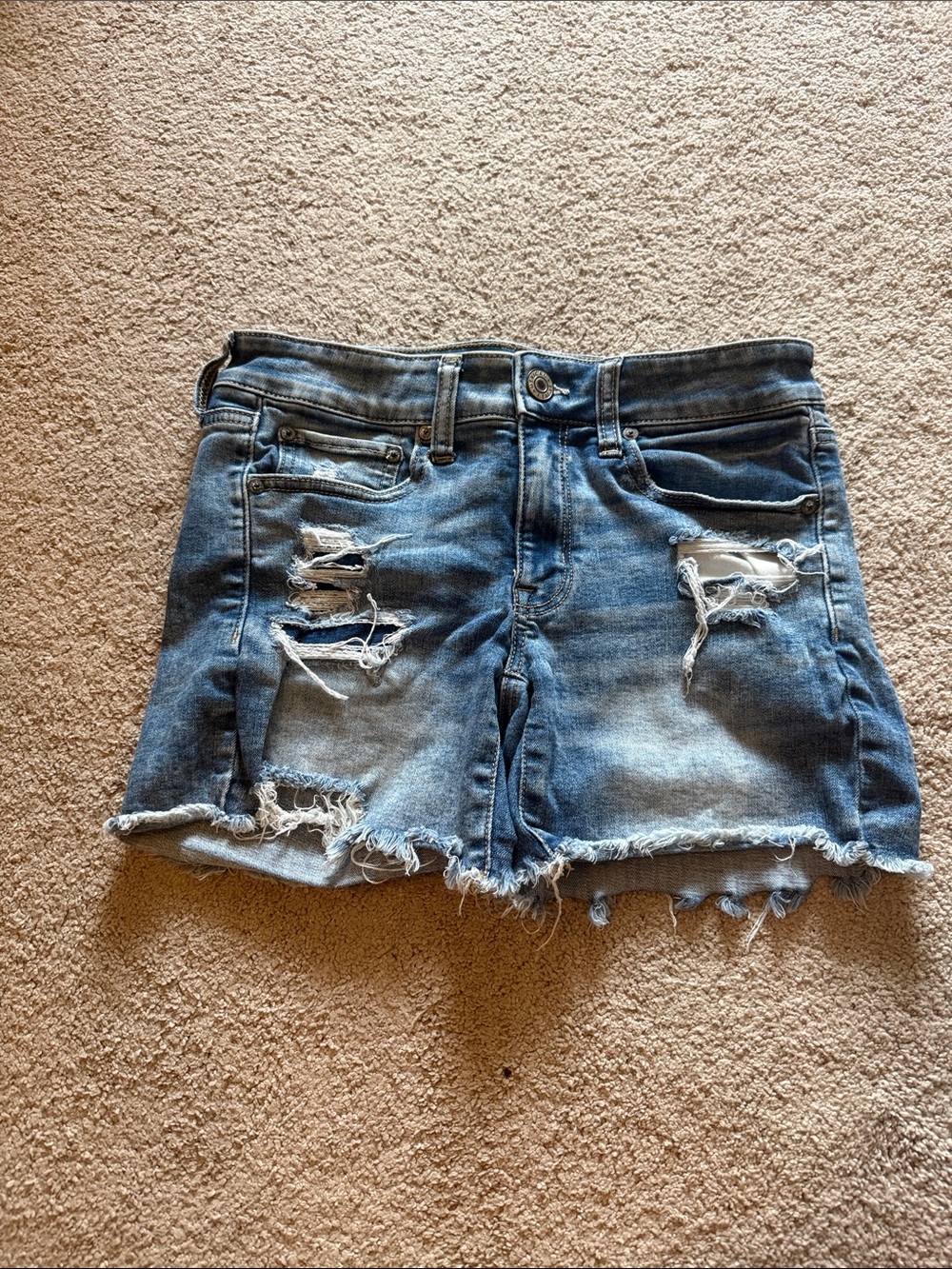 American Eagle Medium Blue Distressed Denim Shorts with frayed hem